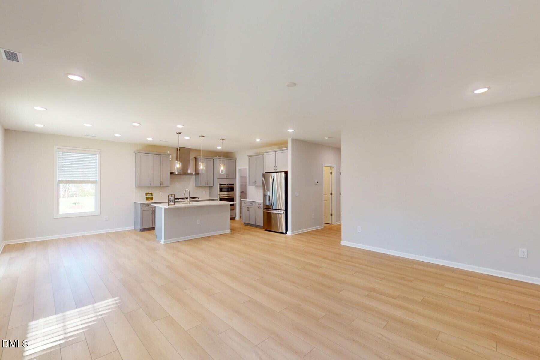 109 Tawny Slope Court, Unit 13 Raleigh, NC 27603 - Photo 10 of 48 a view of a kitchen with a sink and dishwasher a refrigerator with wooden floor