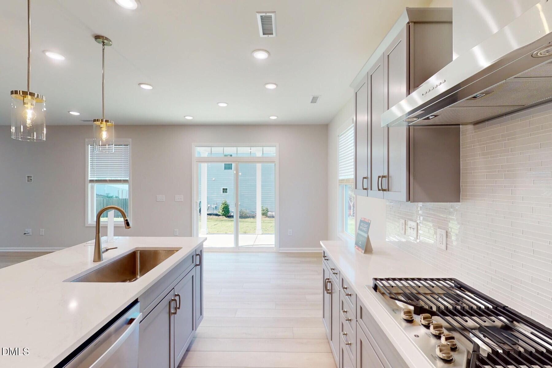 109 Tawny Slope Court, Unit 13 Raleigh, NC 27603 - Photo 13 of 48 a kitchen with counter top space a sink stainless steel appliances and cabinets
