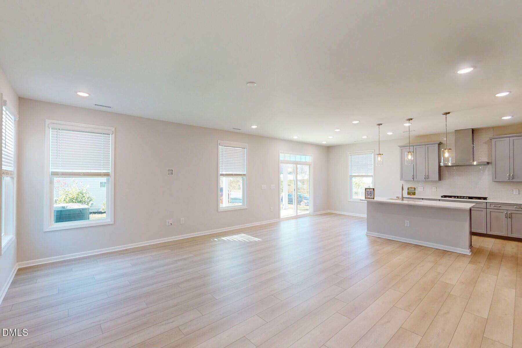 109 Tawny Slope Court, Unit 13 Raleigh, NC 27603 - Photo 15 of 48 a view of kitchen with wooden floor and windows