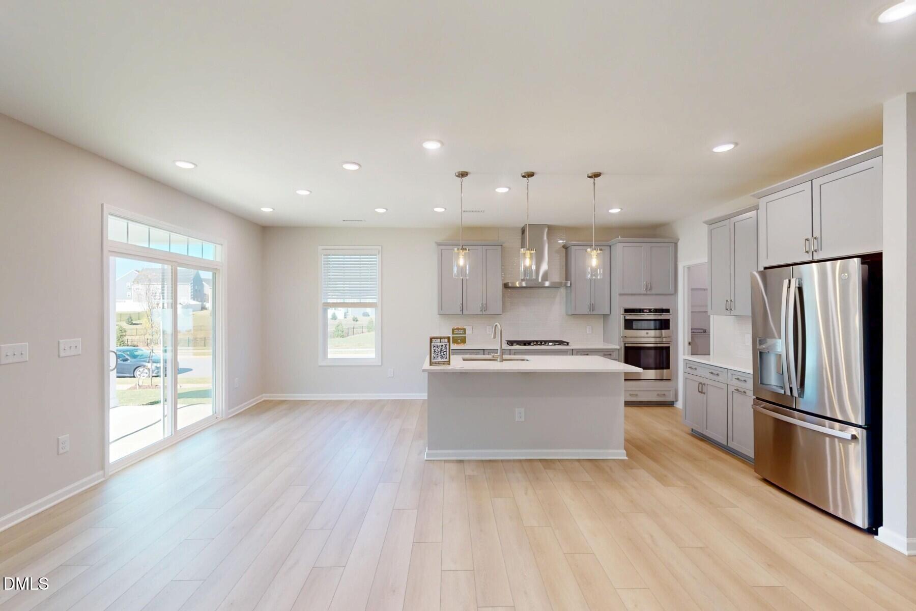 109 Tawny Slope Court, Unit 13 Raleigh, NC 27603 - Photo 5 of 48 a kitchen with a refrigerator and a stove top oven