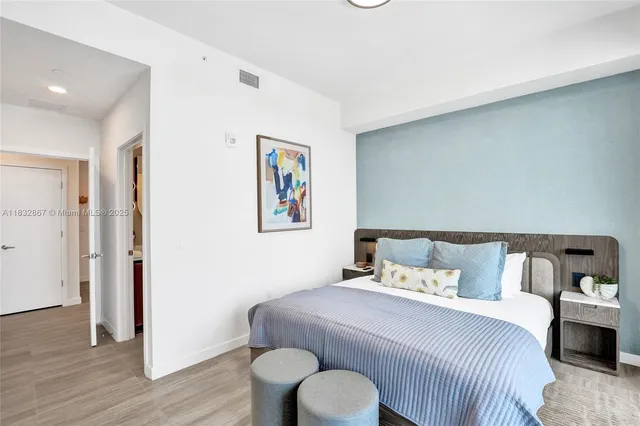 a bedroom with a bed and wooden floor