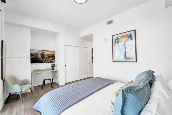 a bedroom with a bed and a couch
