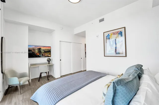 a bedroom with a bed and a couch