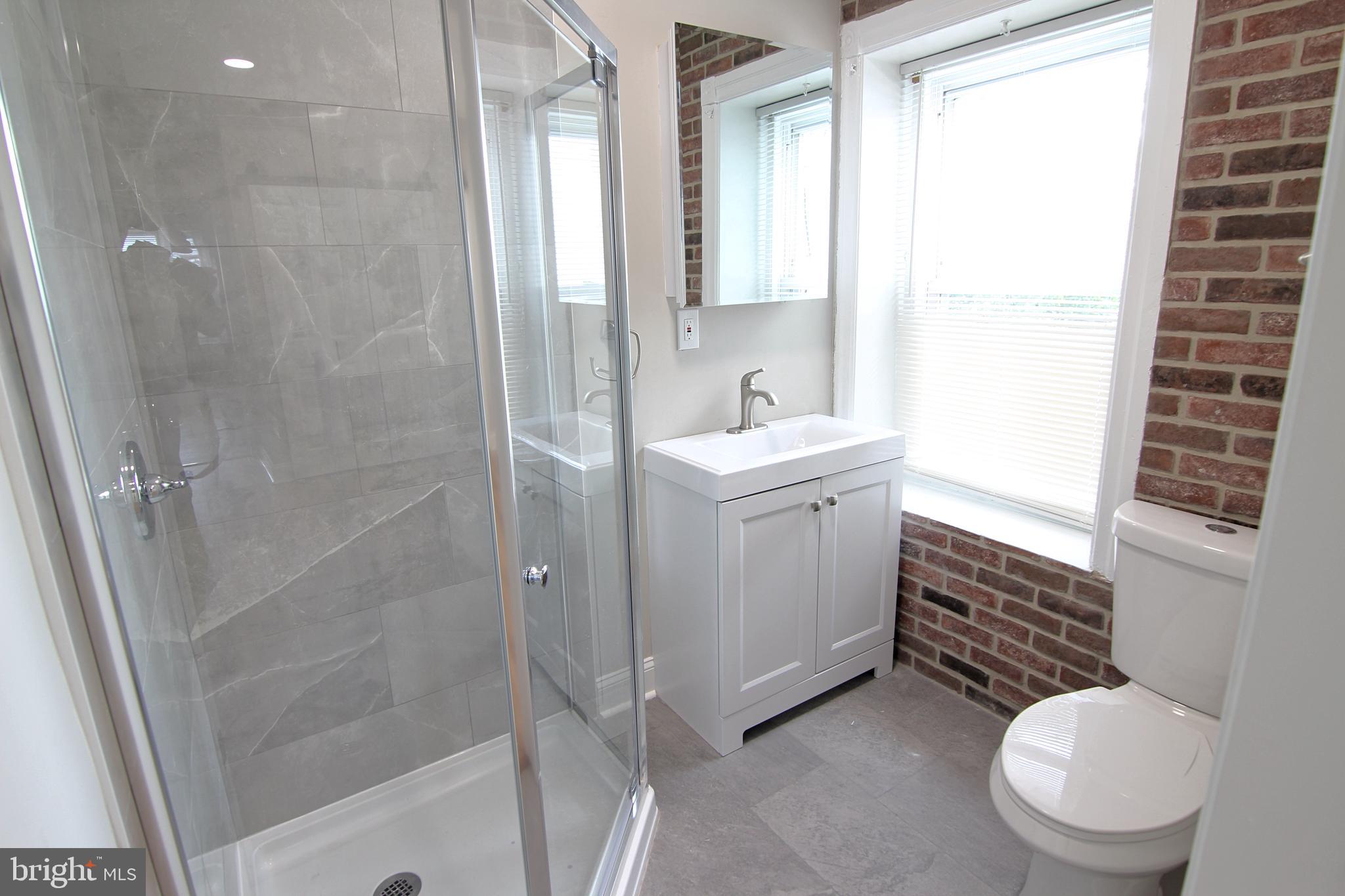 37 Sixth Street, Unit 2 Bridgeport, PA 19405 - Photo 10 of 14 a bathroom with a sink a toilet and shower