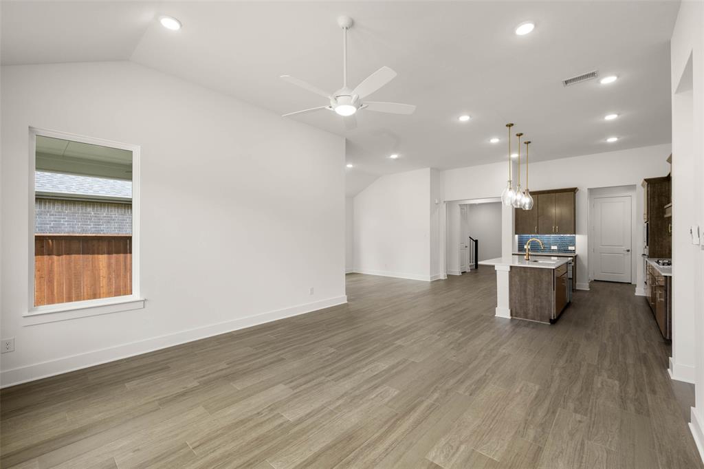 2223 Shady Elm Road Midlothian, TX 76065 - Photo 12 of 27 an open kitchen with a refrigerator and windows