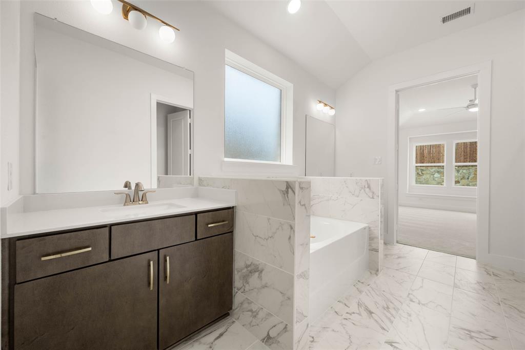 2223 Shady Elm Road Midlothian, TX 76065 - Photo 18 of 27 a bathroom with a tub sink and mirror
