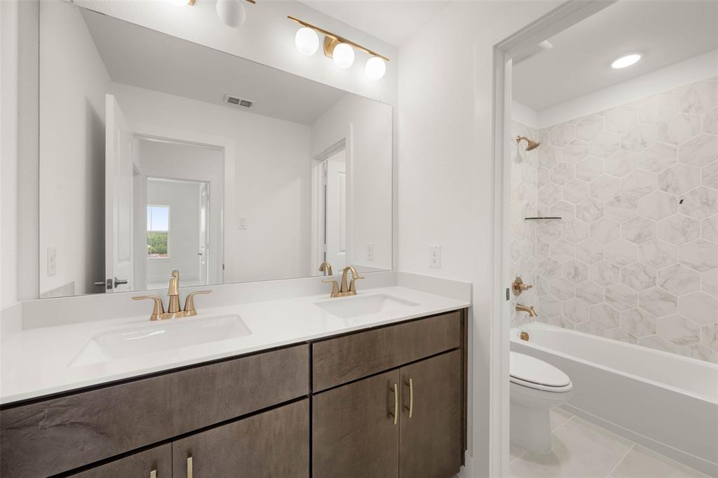 2223 Shady Elm Road Midlothian, TX 76065 - Photo 20 of 27 a bathroom with a sink a toilet a shower and a mirror