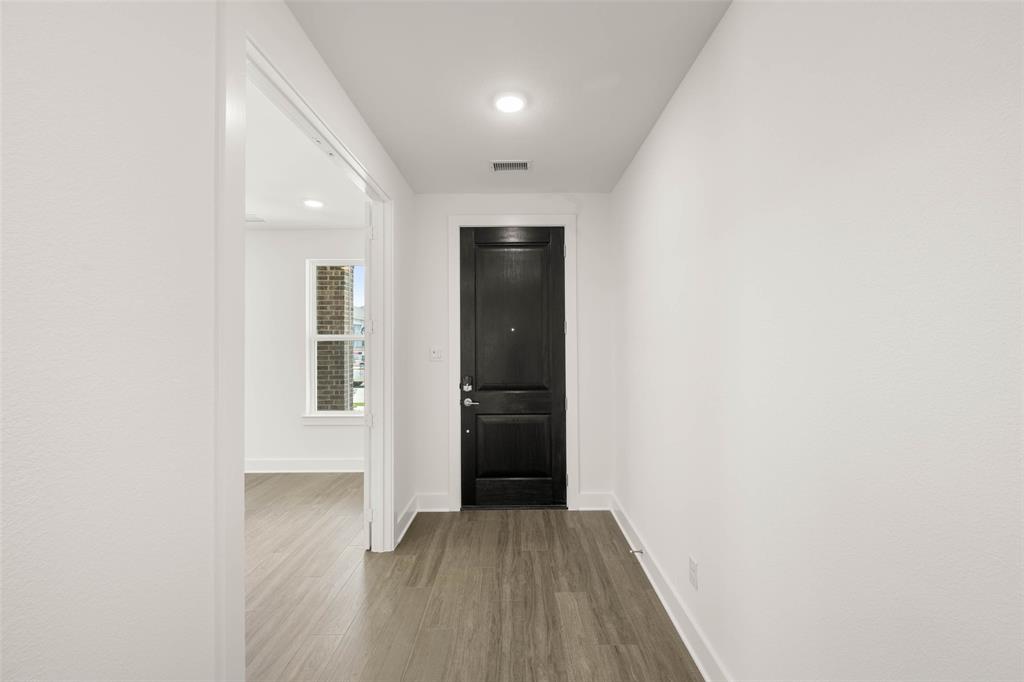 2223 Shady Elm Road Midlothian, TX 76065 - Photo 3 of 27 a view of a hallway with wooden floor and closet