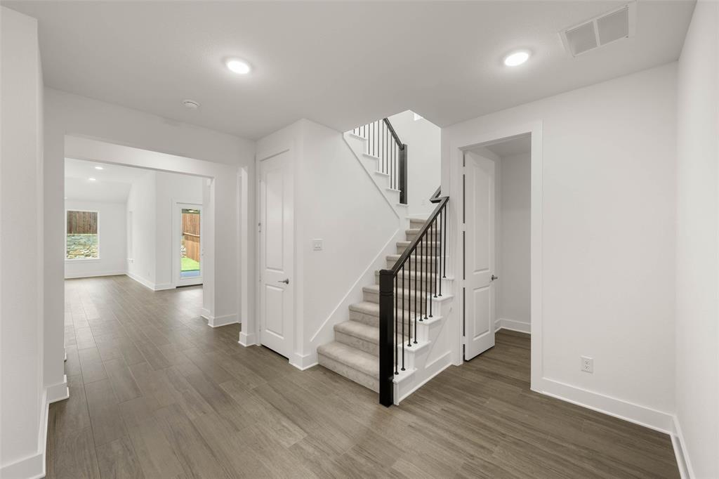 2223 Shady Elm Road Midlothian, TX 76065 - Photo 4 of 27 a view of a hallway with wooden floor and stairs