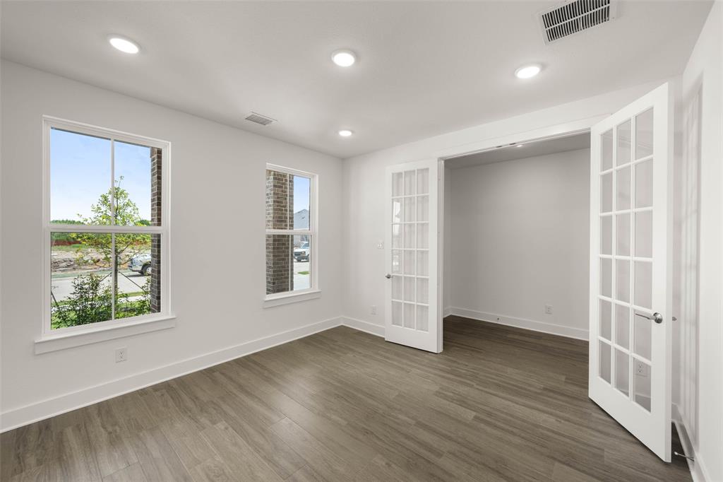 2223 Shady Elm Road Midlothian, TX 76065 - Photo 5 of 27 an empty room with wooden floor and windows