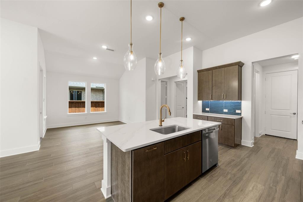 2223 Shady Elm Road Midlothian, TX 76065 - Photo 9 of 27 a kitchen with a sink a stove a refrigerator and white cabinets