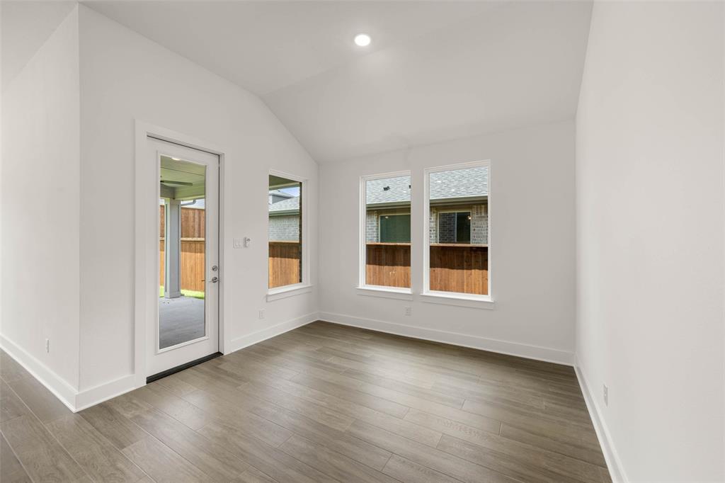 2223 Shady Elm Road Midlothian, TX 76065 - Photo 10 of 27 an empty room with wooden floor and windows
