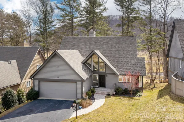a view of a house with a yard covered in snow