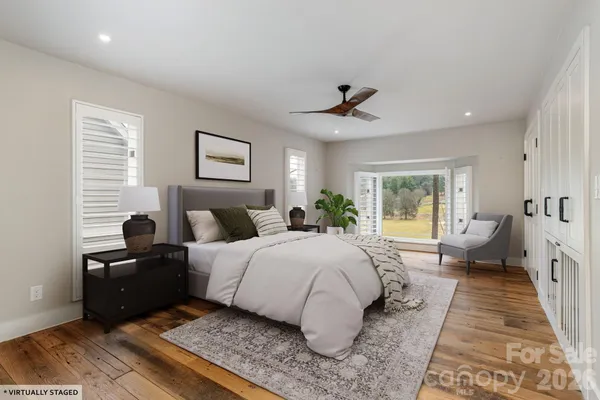 a spacious bedroom with a large bed and a chandelier