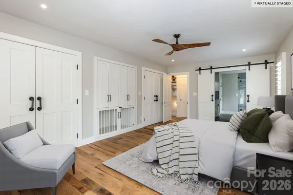 a bedroom with a bed and a couch