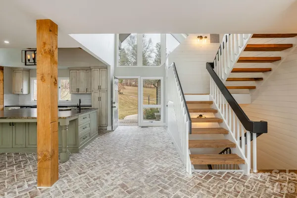 a view of a kitchen with wooden floor and electronic appliances