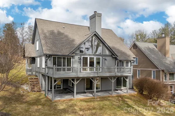 a front view of a house with a garden and plants