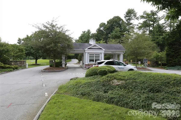 a front view of a house with a garden and trees
