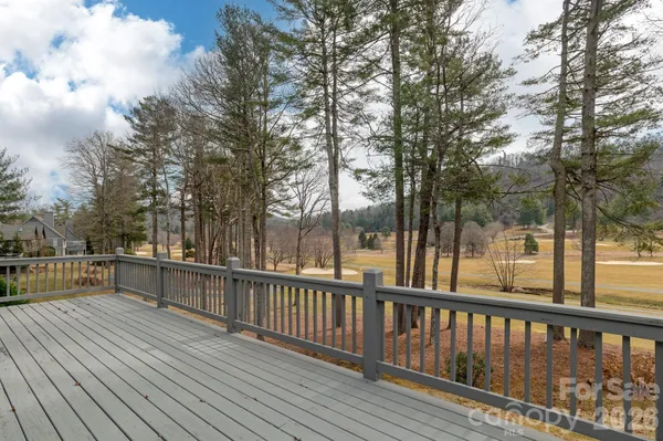 a view of a wooden deck with trees