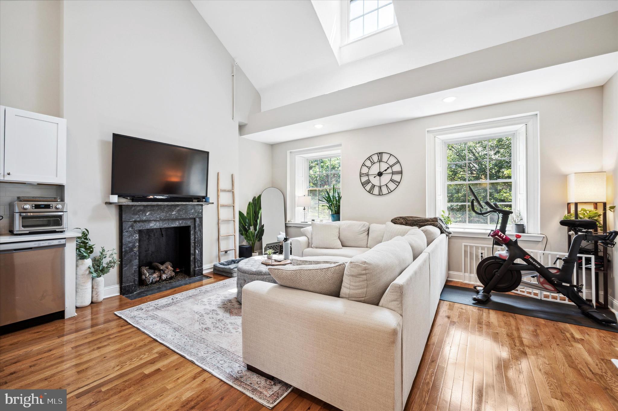 a living room with fireplace furniture and a fireplace
