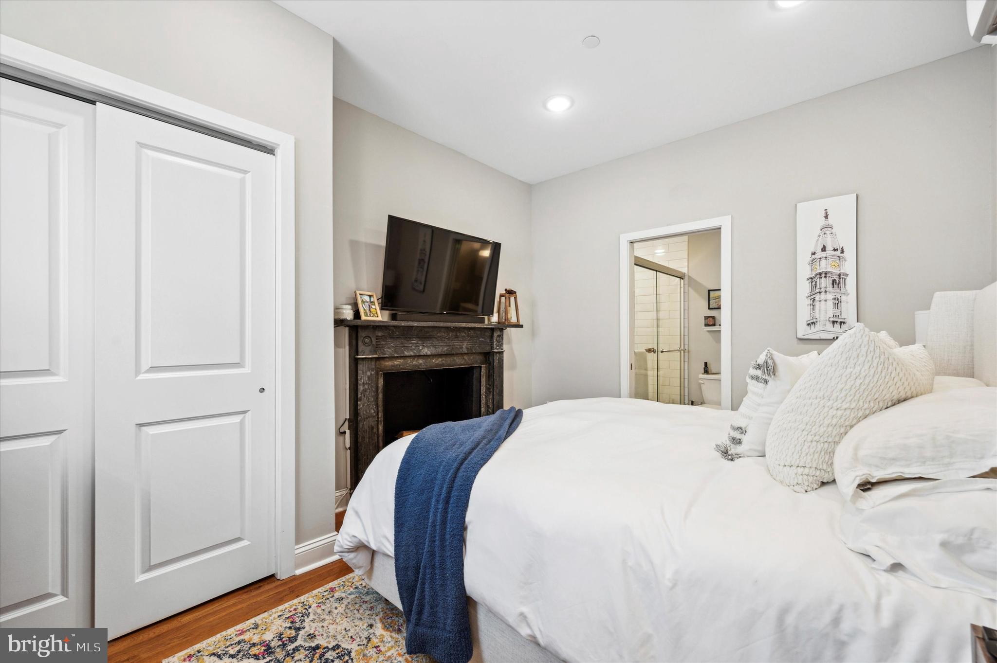 1015 Clinton Street, Unit 3 Philadelphia, PA 19107 - Photo 13 of 25 a bedroom with a bed and a television