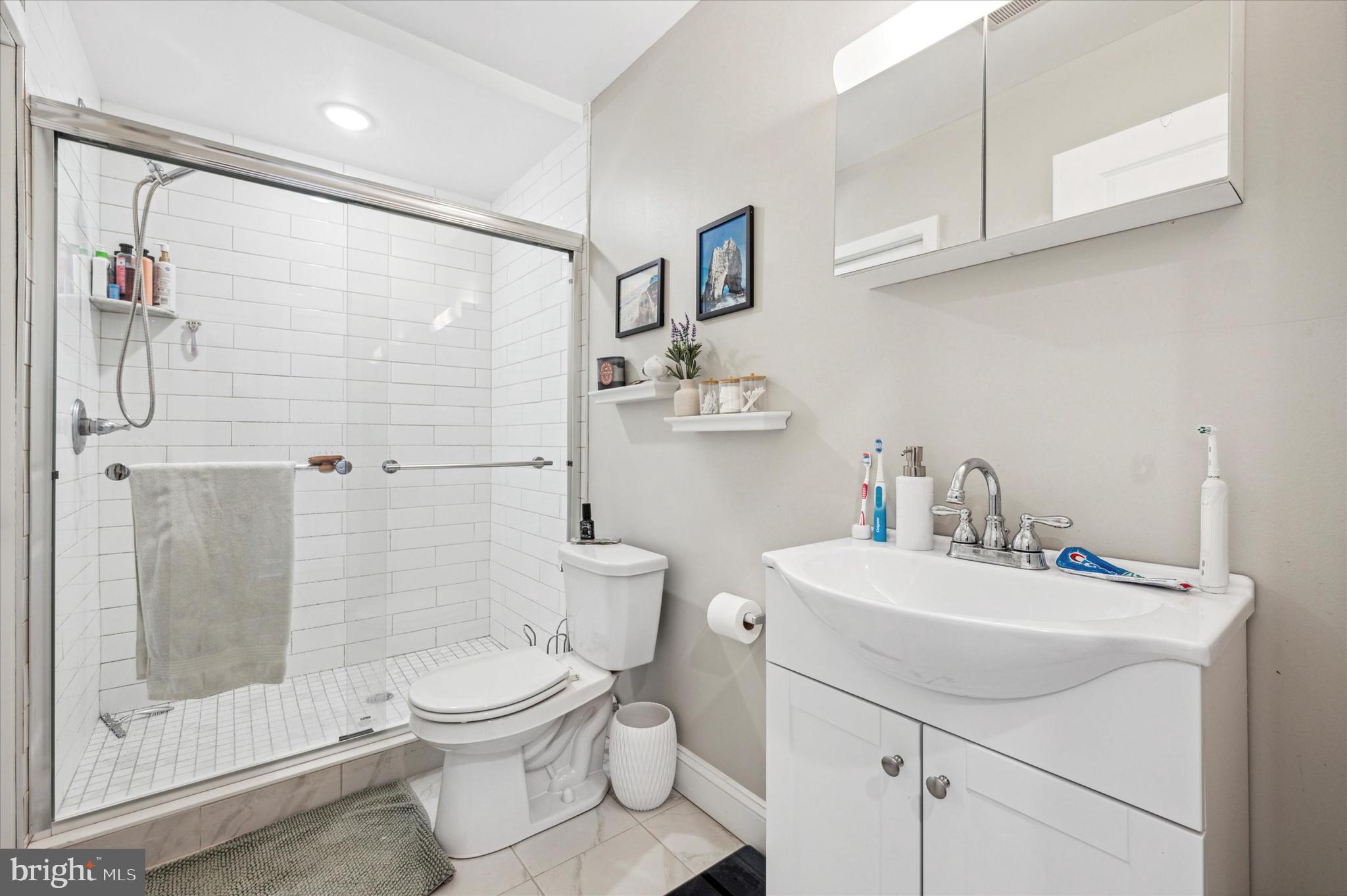 1015 Clinton Street, Unit 3 Philadelphia, PA 19107 - Photo 14 of 25 a bathroom with a sink toilet and shower
