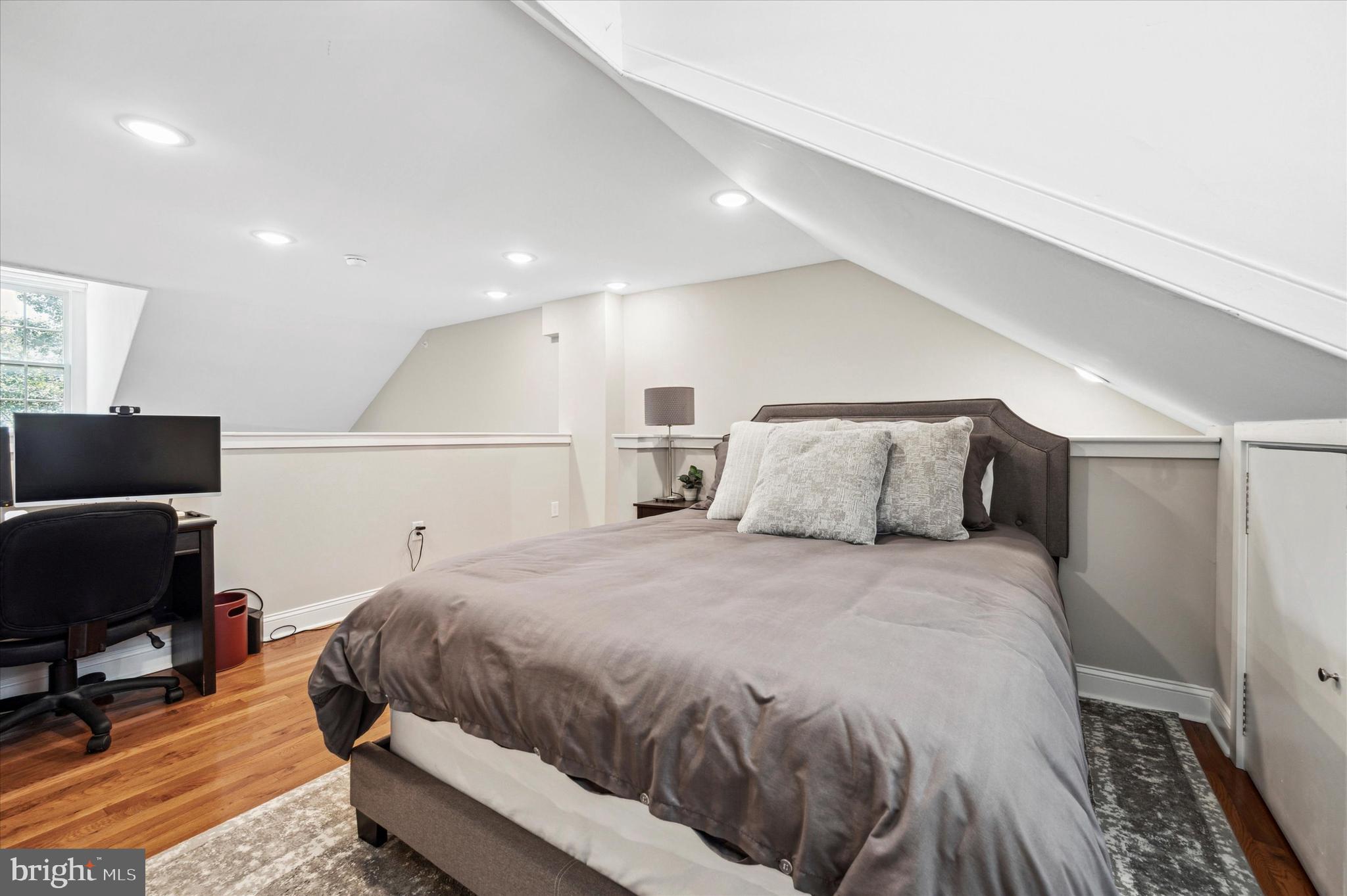 1015 Clinton Street, Unit 3 Philadelphia, PA 19107 - Photo 17 of 25 a bedroom with a bed and a chair