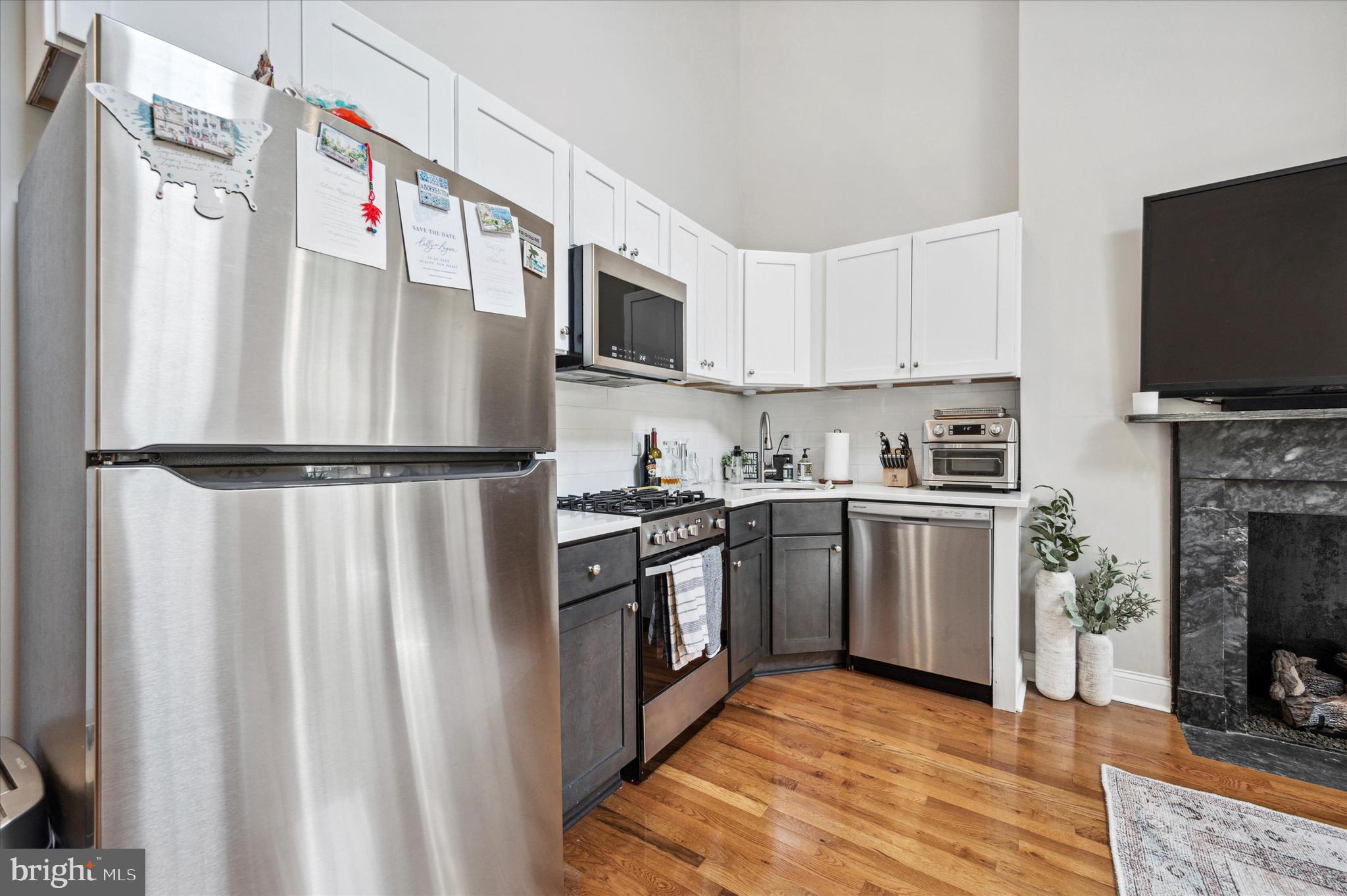 1015 Clinton Street, Unit 3 Philadelphia, PA 19107 - Photo 6 of 25 a kitchen with stainless steel appliances granite countertop a refrigerator a stove top oven a sink and dishwasher