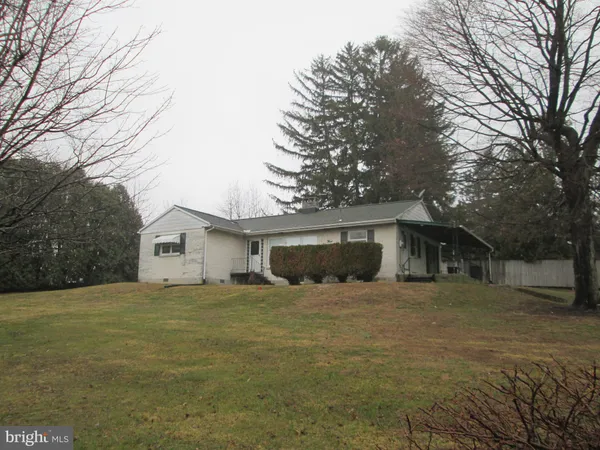 a house that has a tree in front of it