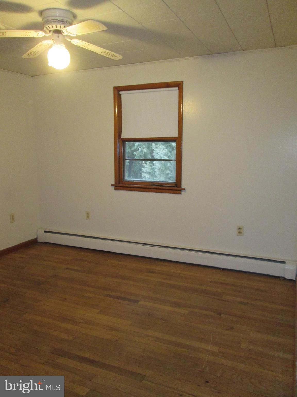 315 York Road Carlisle, PA 17013 - Photo 11 of 14 a view of an empty room with wooden floor and fan