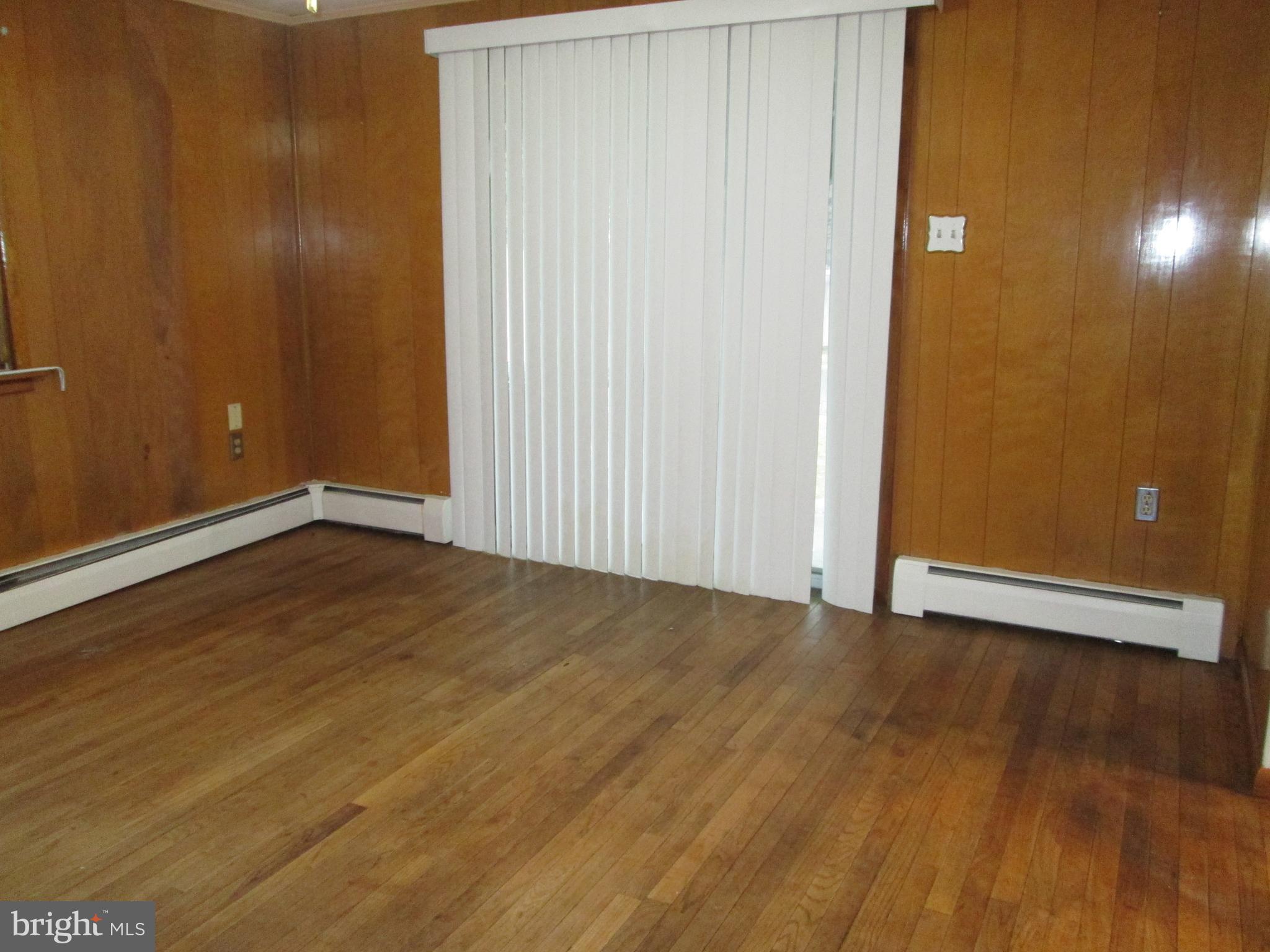 315 York Road Carlisle, PA 17013 - Photo 4 of 14 an empty room with wooden floor and windows