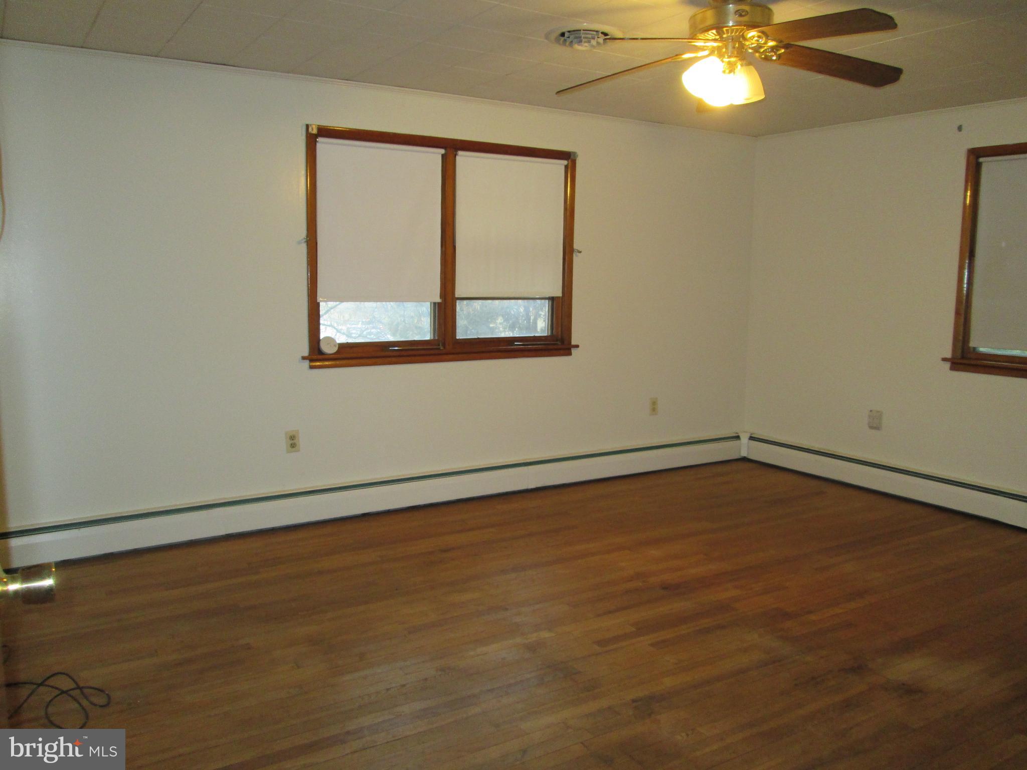 315 York Road Carlisle, PA 17013 - Photo 9 of 14 a view of an empty room with wooden floor and a window