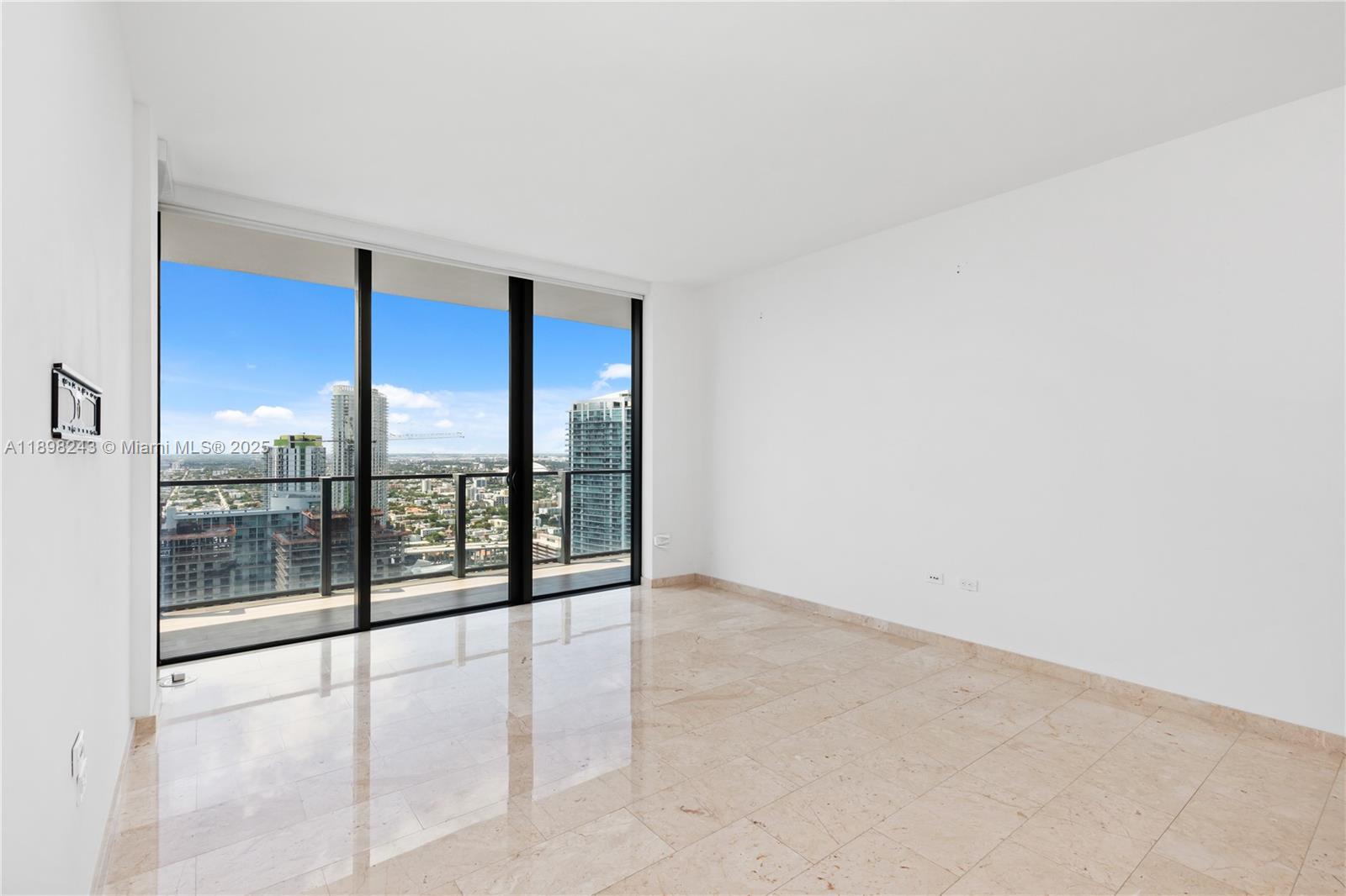 68 Southeast 6th Street, Unit 3906 Miami, FL 33131 - Photo 14 of 48 an empty room with sliding glass door