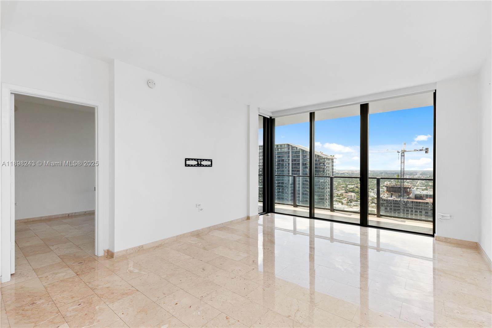 68 Southeast 6th Street, Unit 3906 Miami, FL 33131 - Photo 15 of 48 an empty room with sliding glass door and shower