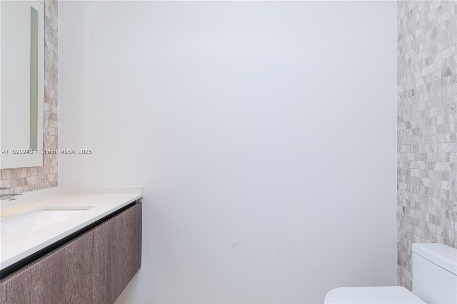 68 Southeast 6th Street, Unit 3906 Miami, FL 33131 - Photo 27 of 48 a bathroom with a sink and a toilet