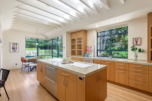 a room with sink attached with living room furniture and a large window