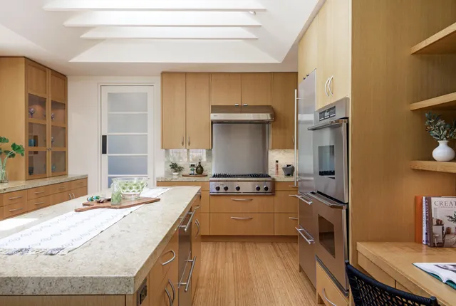 a kitchen with granite countertop a sink stove and refrigerator