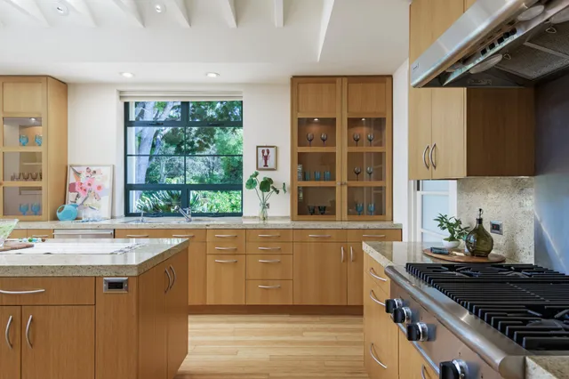 a kitchen with a sink and large window