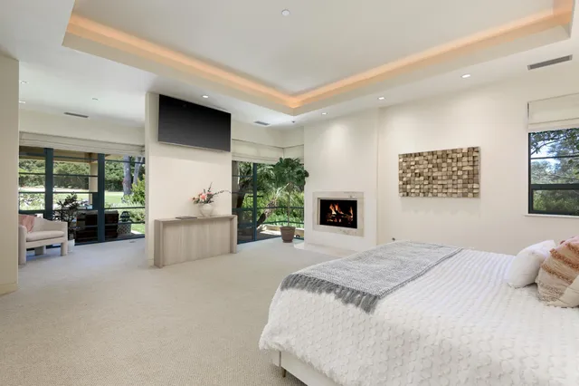 a spacious bedroom with a large bed couch and a window