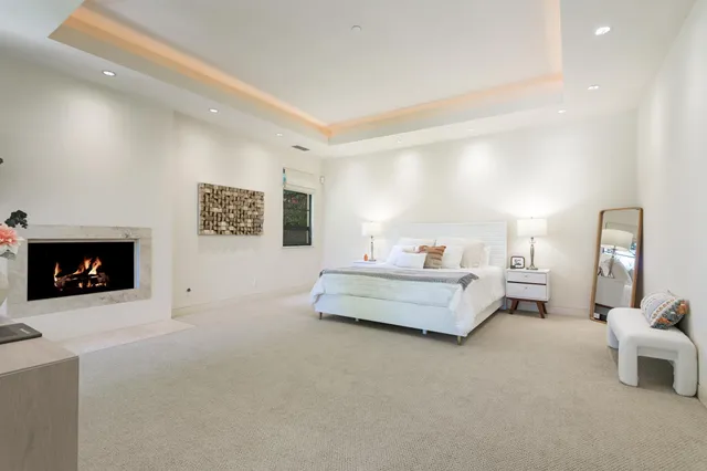 a bedroom with furniture and a fireplace