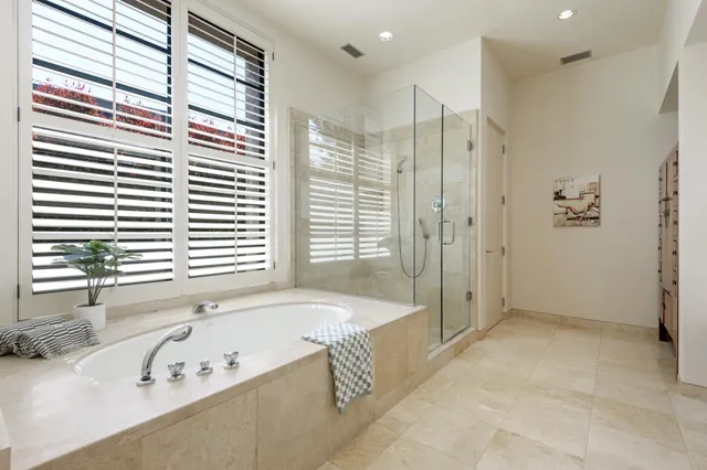 a bathroom with a bathtub and a shower