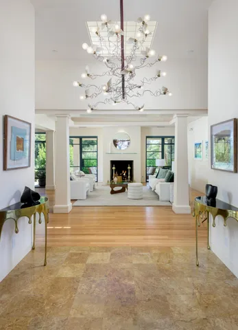 a living room with fireplace furniture and a chandelier