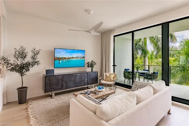 a living room with furniture a lamp and a potted plant