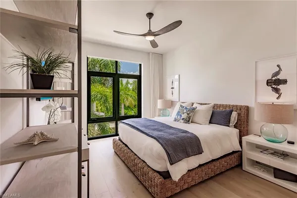 a bedroom with a large bed and a window