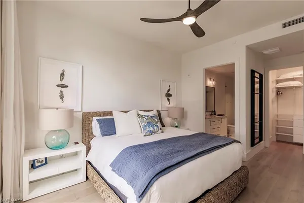 a bedroom with a bed and cabinets