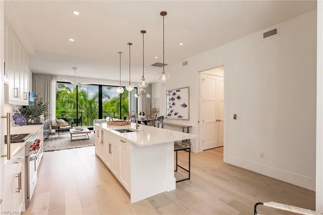 a large room with a large window and furniture