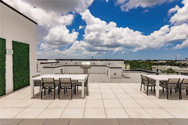 a view of a patio with dining table and chairs