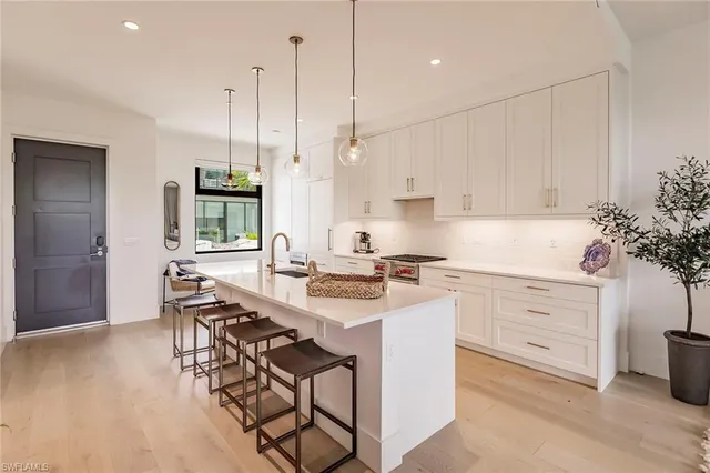 a kitchen with a table chairs stove and cabinets