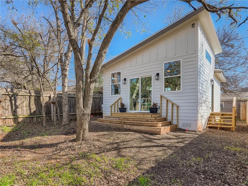 1614 Elmira Road Austin, TX 78721 - Photo 11 of 23 Back of property featuring board and batten siding, a fenced backyard, crawl space, and a deck