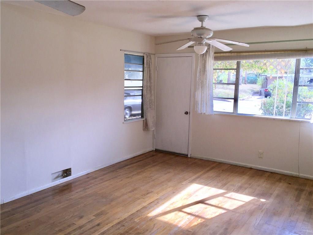 1614 Elmira Road Austin, TX 78721 - Photo 15 of 23 Unfurnished room with healthy amount of natural light, light wood-type flooring, and a ceiling fan